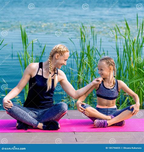 Portrait of Mother and Daughter Sitting on Yoga Mat Stock Image - Image