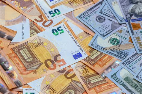 50 euros on top of one hundred dollar bills. Trading Euro with Dollar 3