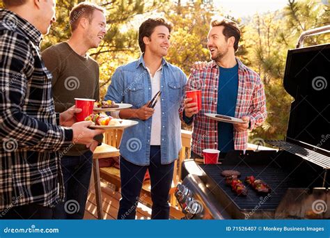 Group of Gay Male Friends Enjoying Barbeque Together Stock Image