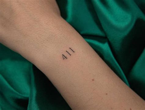 Tattoo of the number "411" placed on the wrist.