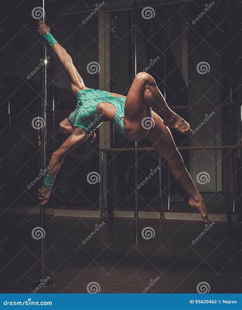 Beautiful Woman Performing Pole Dance on Pole Stock Photo - Image of