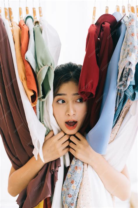 Premium Photo | Asian girl stuck in her mess of clothes