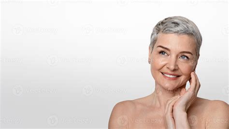 Skincare And Beauty. Gorgeous Nude Middle Aged Woman Touching Her Soft