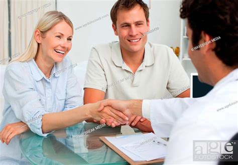 Smiling couple greeting their doctor, Stock Photo, Picture And Royalty ...