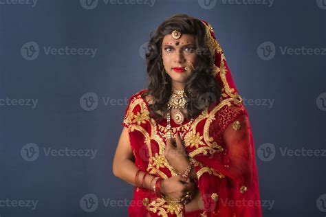Young crossdresser man wearing Indian wedding clothes of a bride with ...