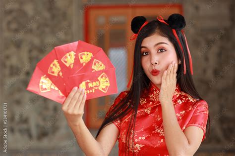 Beautiful Asian woman stand with red dress traditional cheongsam qipao