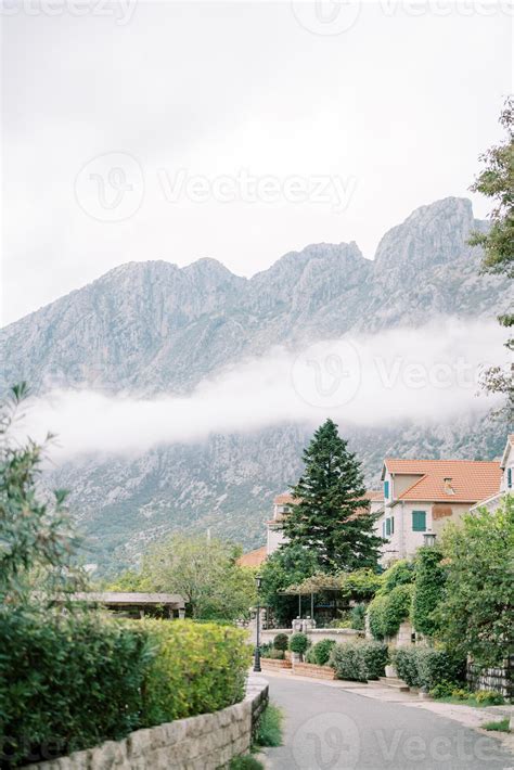 Narrow street of an ancient town with stone houses at the foot of the