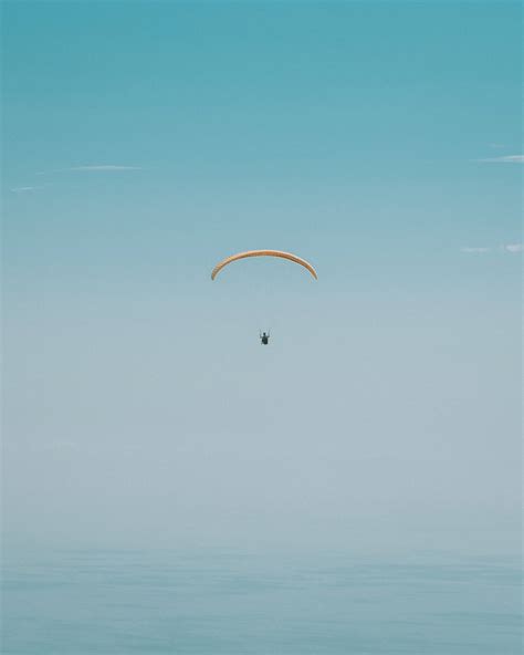 Download Paragliding Light Blue Sky Wallpaper | Wallpapers.com