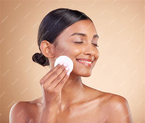 Premium Photo | Smile makeup or happy woman with cotton pad in studio