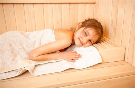 Portrait of little girl lying on towel at sauna — Stock Photo © Kryzhov ...