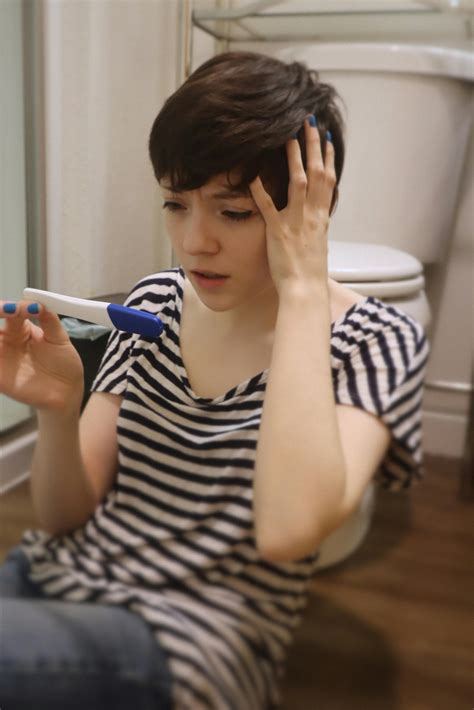 Woman or teen looking confused at pregnancy test resultsFree Stock Photo