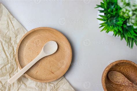 Wooden utensils on the kitchen table. Round wooden plates, a wooden