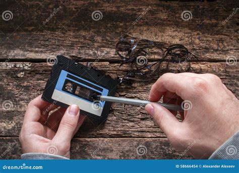 Man rewind a cassette tape stock photo. Image of record - 58666454