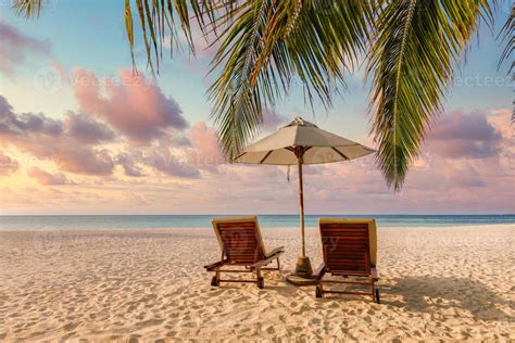 Amazing sunset beach. Romantic couple chairs umbrella. Tranquil