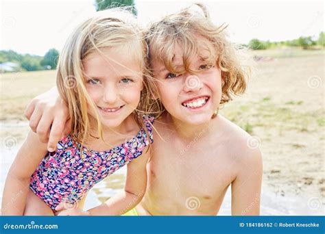 Brother and Sister are Smiling Happily on the Beach Stock Photo - Image ...