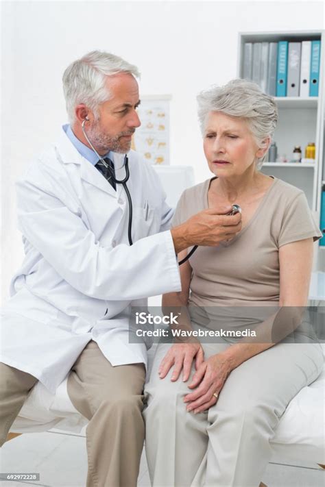 doctor checking patients heartbeat  stethoscope stock photo