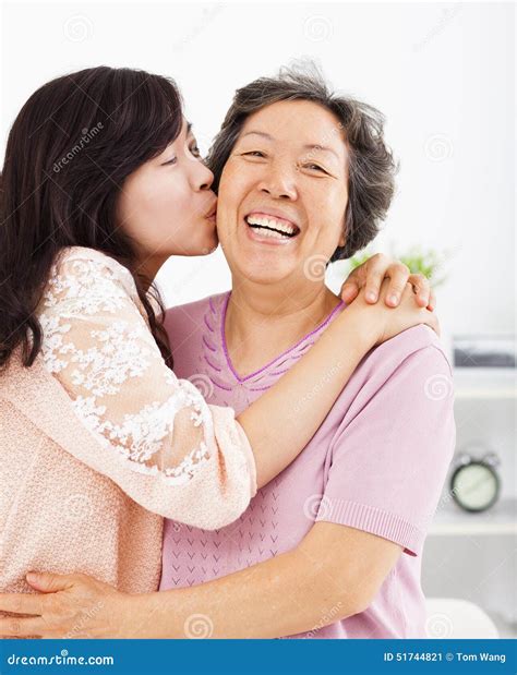 Happy Daughter Kissing Her Mother Royalty-Free Stock Photography