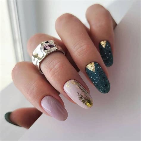 a woman's hand with some manies and gold glitters on her nails
