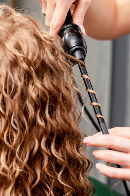 premium photo making curls  curling iron
