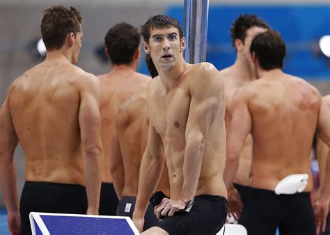 Michael Phelps of the U.S. looks down at the pool after his team was