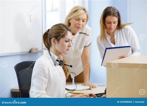 Young Woman Training at Reception Desk Stock Image - Image of elegant