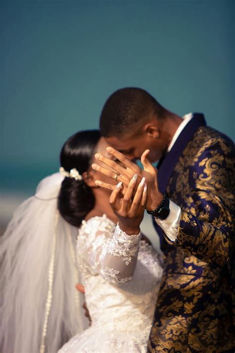 Wedding black couple kissing and showing ring on ring finger · Free