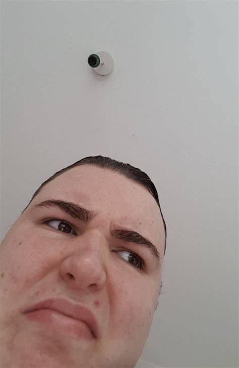 a man looking up at the ceiling with an object above his head in the ...