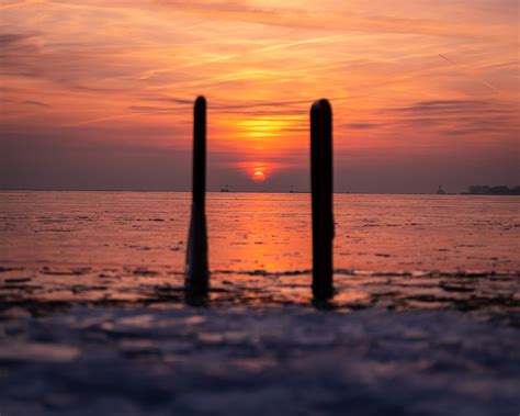 Sunrise over freezing Lake Michigan : r/pics