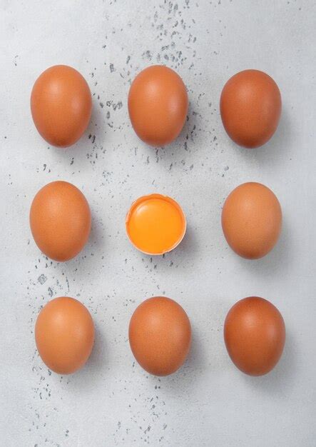 premium photo concept raw fresh eggs  shell  yolk  light