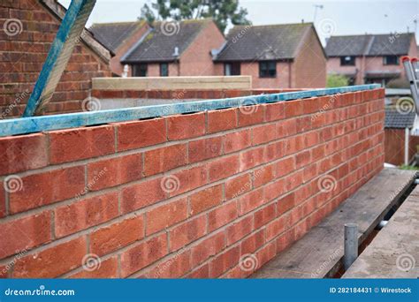 Red Brick Wall in the Process of Construction. Stock Image - Image of ...