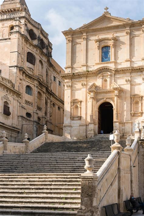 Noto,Italy-May 7, 2022 people stroll in Noto in front off the Church of