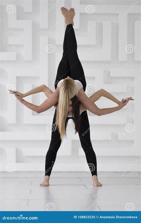 Two Young Girls Practicing Acro Yoga Balance Pose, Black Sportswear ...
