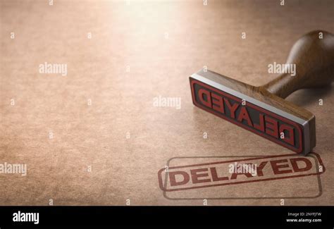 Rubber stamp over cardboard background with the word delayed stamped on ...