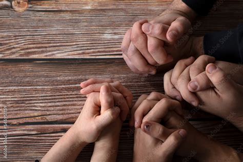 Praying hands on a wooden background with copy space. Top table view ...
