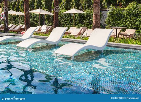 Chaise Lounge In Swimming Pool Stock Photo - Image: 34379980