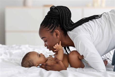 Why Do Babies Grab Your Face? We Explain Why It's Normal