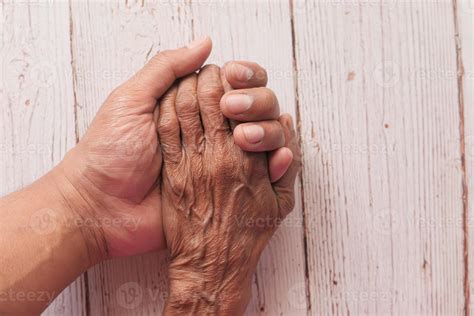 Old person and young person holding hands 2060090 Stock Photo at Vecteezy