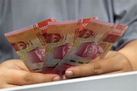 person holding indonesian money  stock photo