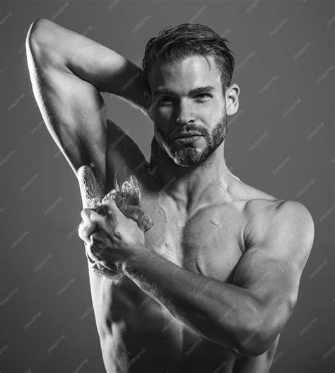 Premium Photo | Bearded macho guy with strong muscles taking shower