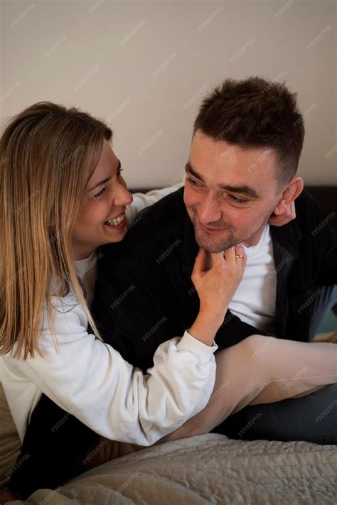 Free Photo | Young couple making each other laugh by tickling