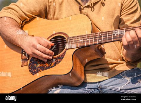 Detail of a rock musician playing a classical guitar Stock Photo - Alamy