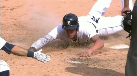 a baseball player sliding into home plate during a game