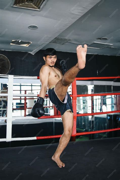Premium Photo | Full Length Of Asian Muay Thai Guy Kick Up With Foot To