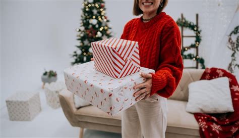 Premium Photo | Cropped view of unrecognizable woman carrying christmas ...