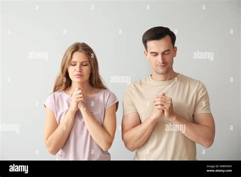 religious couple praying  god  light background stock photo alamy