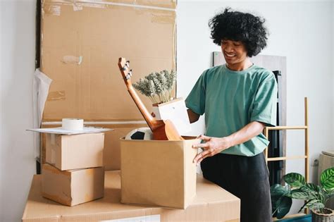 premium photo young asian man putting stuff  carton box preparing