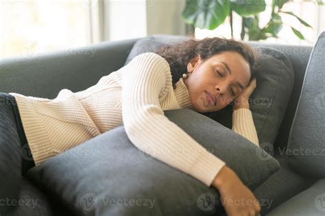 Latin woman sleeping on sofa 6725090 Stock Photo at Vecteezy