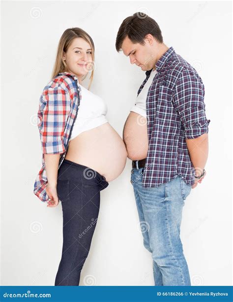 Portrait of Pregnant Woman and Husband Touching with Big Tummies Stock