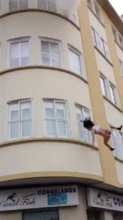 Dramatic footage shows rescuers CATCHING semi-naked woman as she jumps