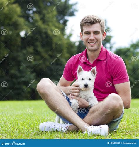 Young Man Playing With His Dog In The Park Stock Image - Image: 48600349